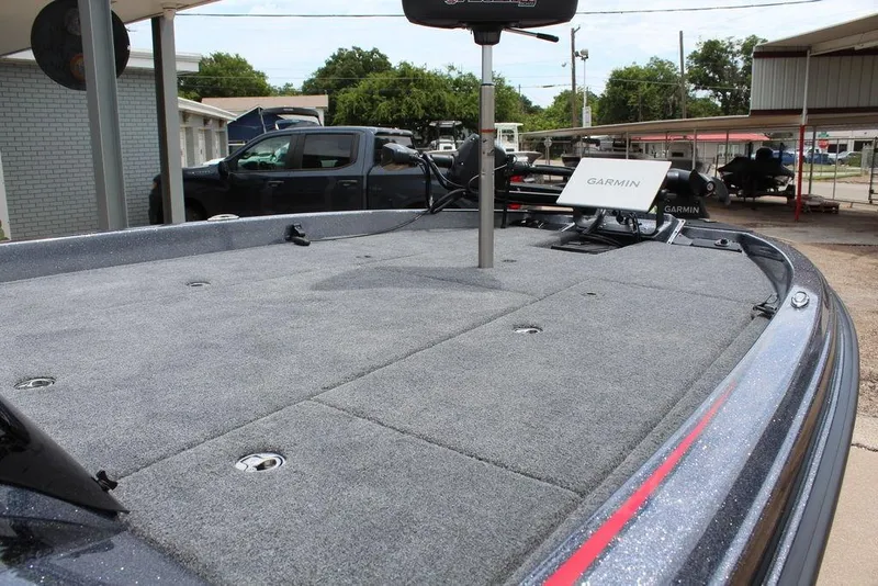 Slide: The Image of 2026 Phoenix 21 XE boat deck with Garmin equipment, parked outdoors. - 15