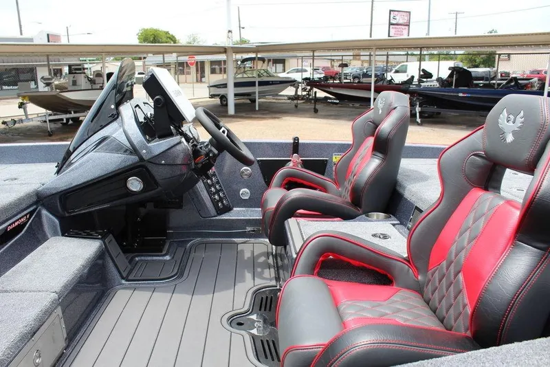 Slide: The Image of 2026 Phoenix 21 XE boat interior with sleek dashboard and red-accented seats. - 18