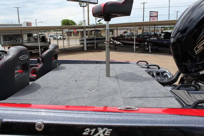 Slide: The Image of 2026 Phoenix 21 XE boat interior with seating and motor, displayed outdoors. - 19