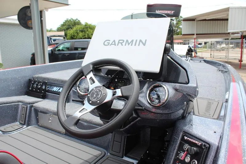 Slide: The Image of 2026 Phoenix 21 XE boat dashboard with Garmin navigation system and steering wheel. - 20