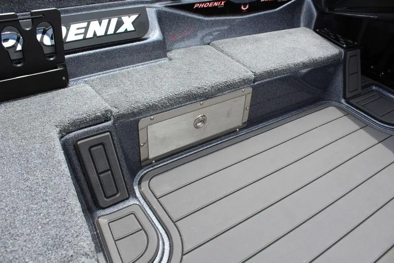 Slide: The Image of Interior of 2026 Phoenix 21 XE boat, featuring storage compartment and carpeted seating. - 22