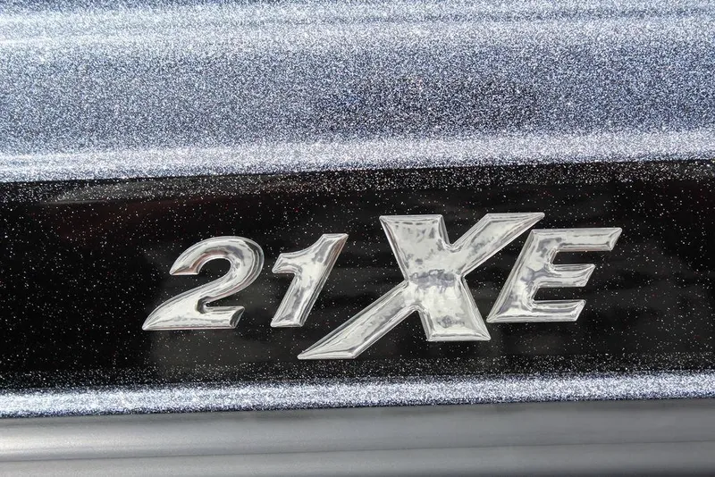 Slide: The Image of Phoenix 21 XE 2026 model emblem on glittery surface. - 23