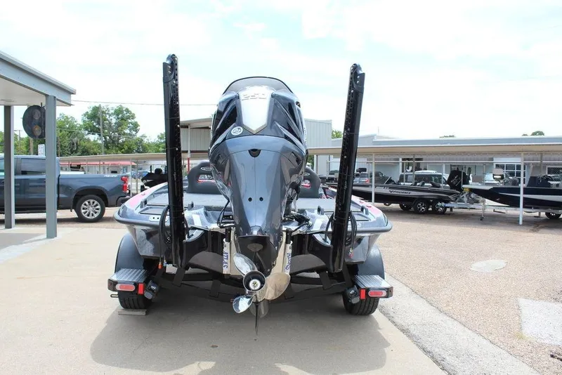 Slide: The Image of 2026 Phoenix 21 XE boat rear view at dealership, showcasing motor and trailer. - 3