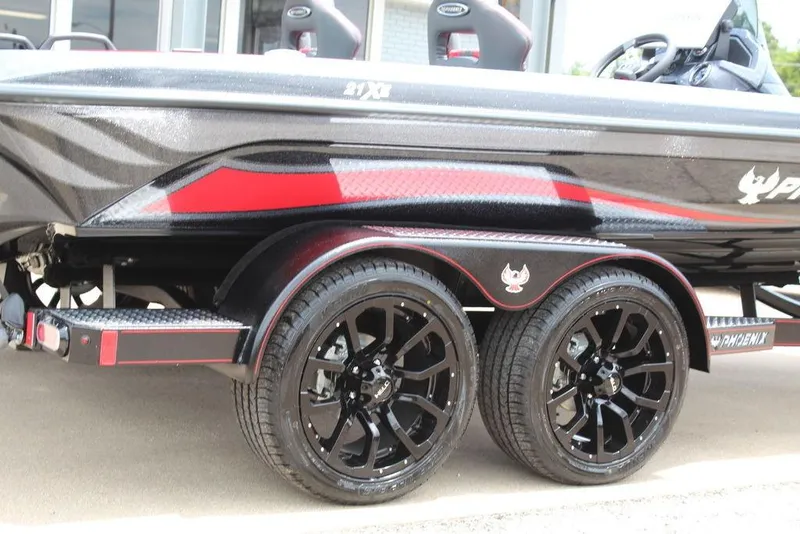 Slide: The Image of 2026 Phoenix 21 XE boat trailer with sleek black and red design, featuring stylish wheels. - 4