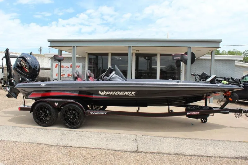 Slide: The Image of 2026 Phoenix 21 XE boat on trailer, displayed outside a dealership. - 5