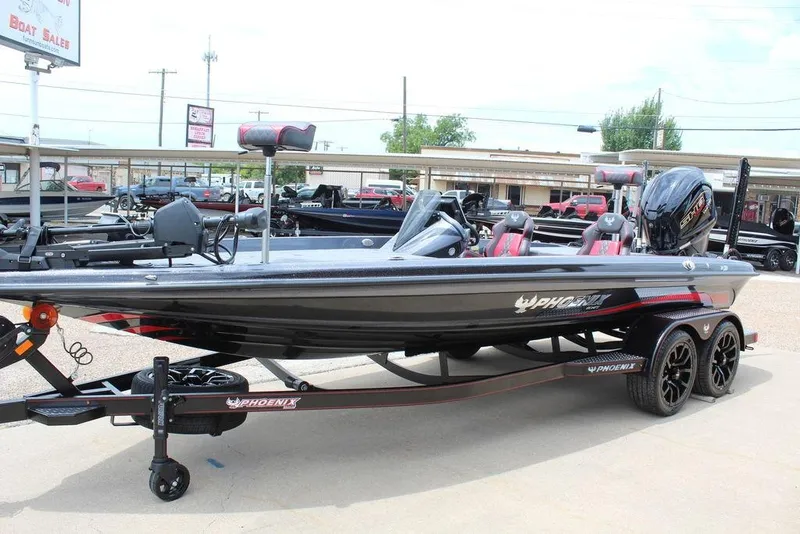 Slide: The Image of 2026 Phoenix 21 XE boat on trailer at dealership, featuring sleek design and modern equipment. - 8