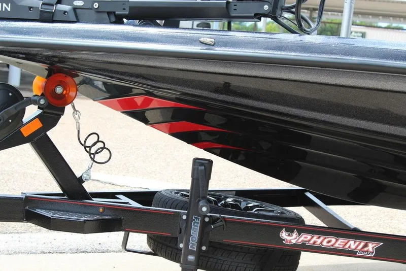 Slide: The Image of 2026 Phoenix 21 XE boat on trailer, featuring sleek black and red design. - 9