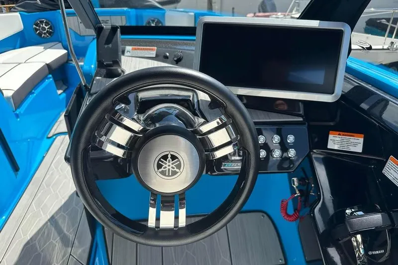 Slide: The Image of 2023 Yamaha Boats 222XD dashboard with steering wheel and touchscreen display. - 3