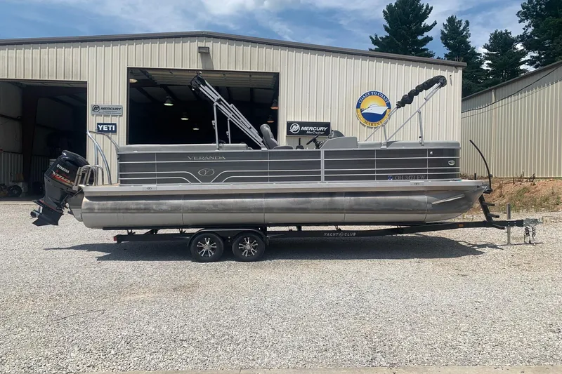 The Image of 2018 Veranda Relax VR 25 RC pontoon boat on trailer outside a storage facility. - 1