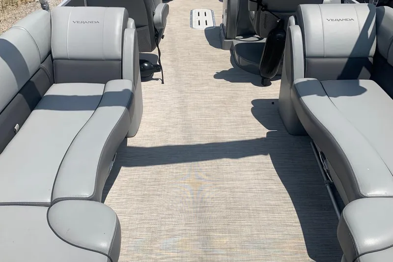 Slide: The Image of 2018 Veranda Relax VR 25 RC pontoon boat interior with gray seating and spacious layout. - 10