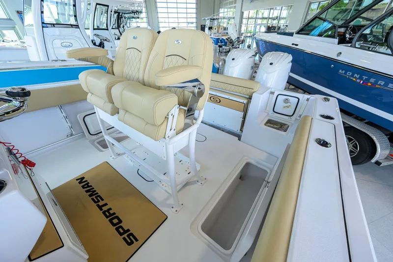 Slide: The Image of 2026 Sportsman Open 252 Center Console boat interior with beige seating and modern design. - 12