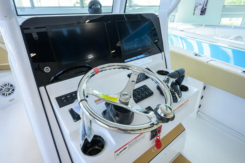 Slide: The Image of 2026 Sportsman Open 252 Center Console boat dashboard with steering wheel and controls. - 15