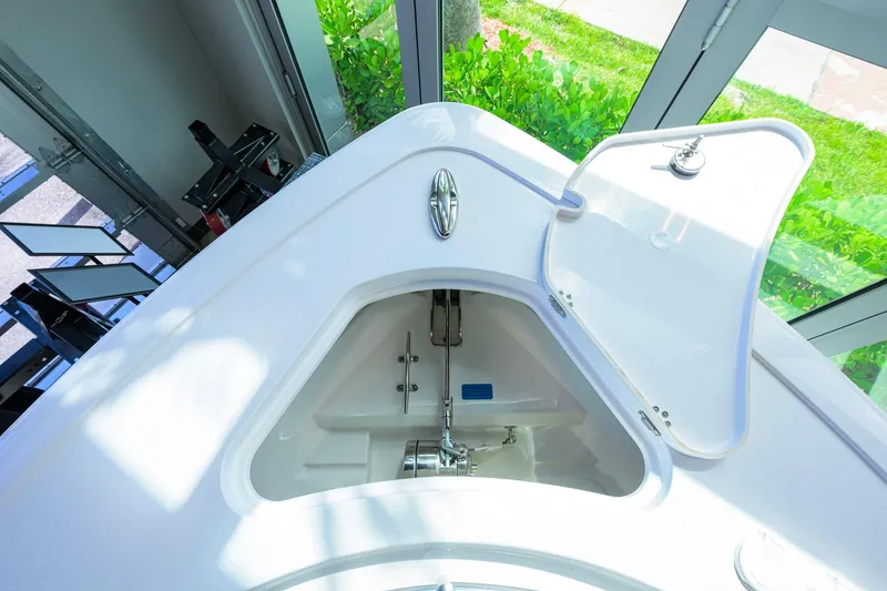 Slide: The Image of 2026 Sportsman Open 252 Center Console anchor locker with open hatch, showcasing storage space. - 24