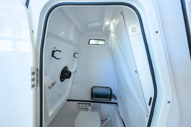 Slide: The Image of Interior of 2026 Sportsman Open 252 Center Console boat, featuring compact cabin space. - 32