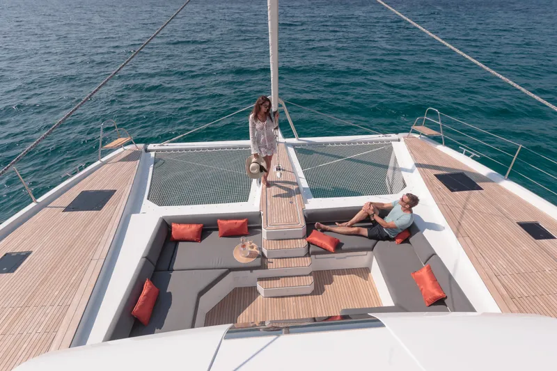 Slide: The Image of 2024 Fountaine Pajot Samana 59 yacht with luxurious outdoor seating and scenic ocean view. - 14