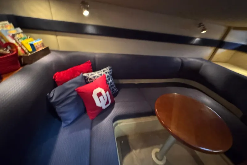 Slide: The Image of Interior of 2005 Cruisers Yachts 340 Express with cozy seating and decorative pillows. - 22