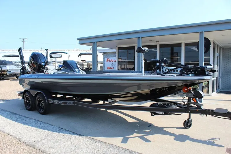 Slide: The Image of 2026 Skeeter ZXE21 boat on trailer outside dealership, showcasing sleek design and modern features. - 1