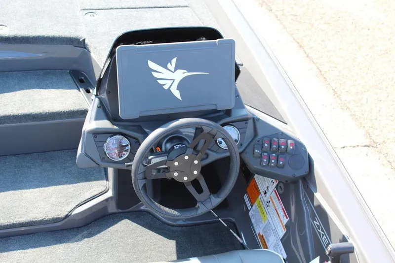 Slide: The Image of 2026 Skeeter ZXE21 boat dashboard with steering wheel and control panel. - 10