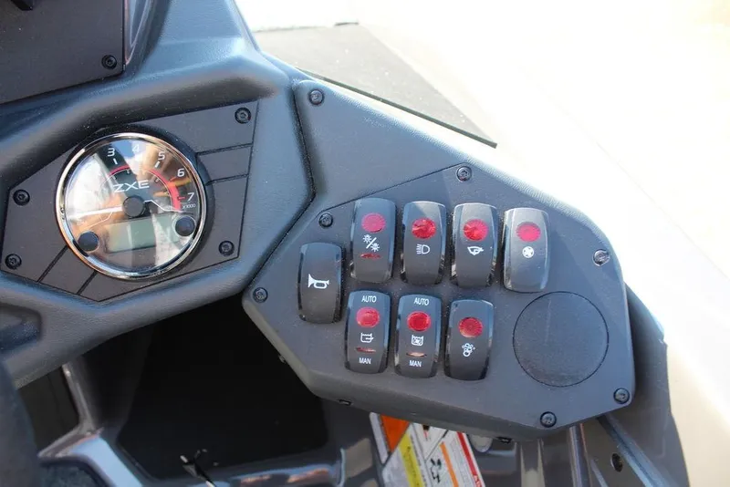 Slide: The Image of Control panel of 2026 Skeeter ZXE21 with switches and gauge display. - 15