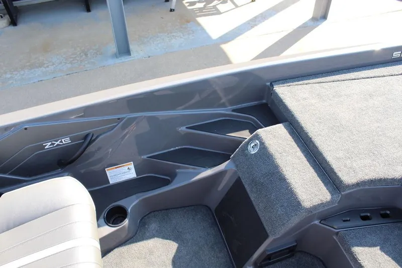 Slide: The Image of 2026 Skeeter ZXE21 boat interior with gray seating and carpeted deck. - 18