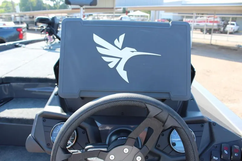 Slide: The Image of 2026 Skeeter ZXE21 boat dashboard with steering wheel and logo display. - 19
