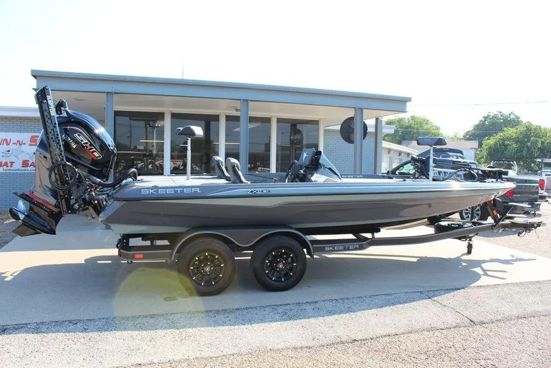 Slide: The Image of 2026 Skeeter ZXE21 boat on trailer, parked outside dealership. - 6
