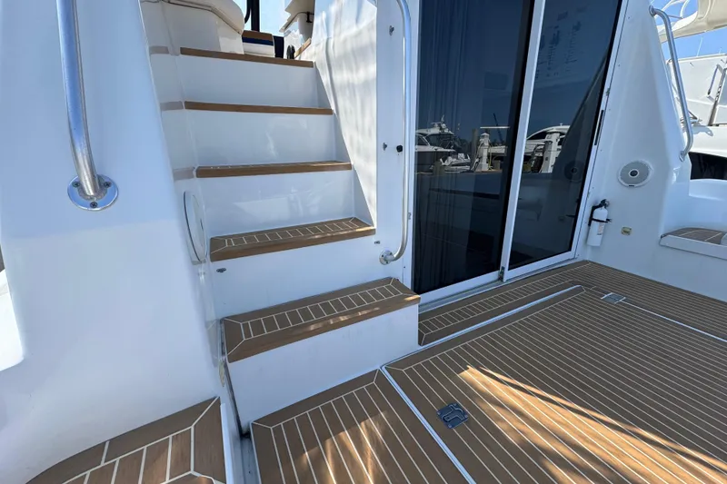 Slide: The Image of 1997 Mainship 40 Sedan Bridge yacht with teak steps and sliding glass door. - 14