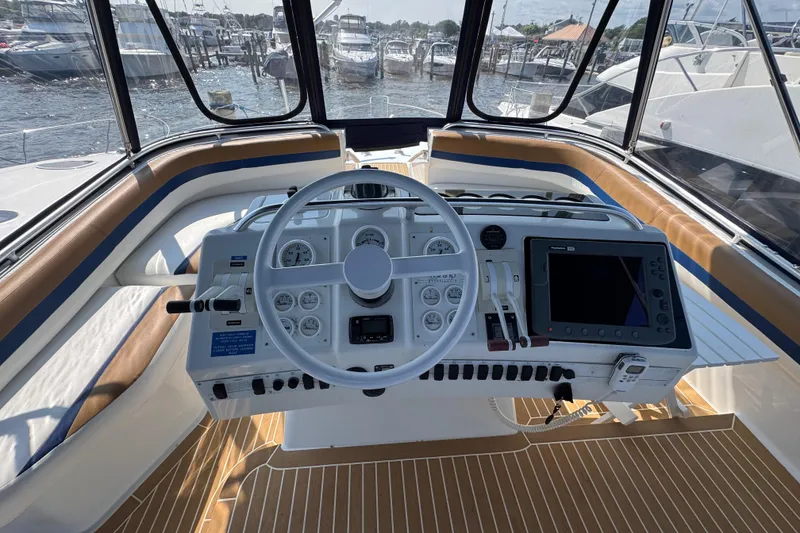 Slide: The Image of 1997 Mainship 40 Sedan Bridge helm with steering wheel, gauges, and navigation equipment. - 15