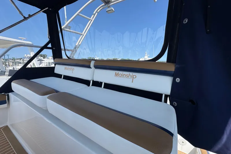 Slide: The Image of 1997 Mainship 40 Sedan Bridge interior seating with blue and white upholstery. - 17