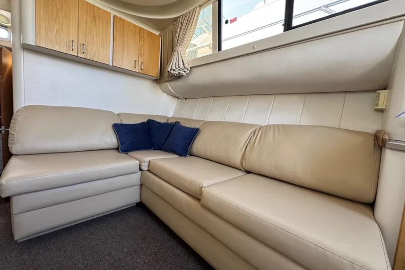 Slide: The Image of Luxurious beige leather seating in 1997 Mainship 40 Sedan Bridge interior. - 23