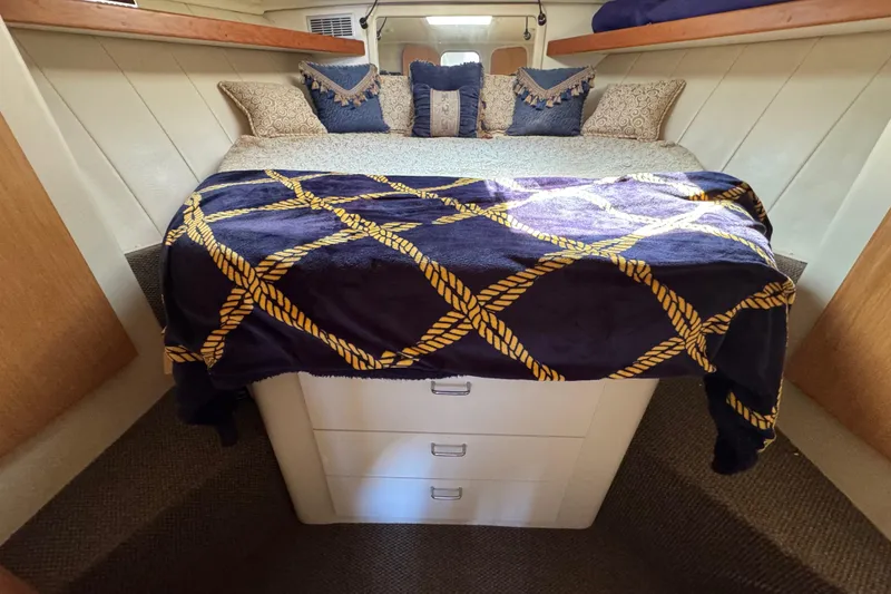 Slide: The Image of Cozy bedroom in 1997 Mainship 40 Sedan Bridge with nautical-themed bedding. - 29