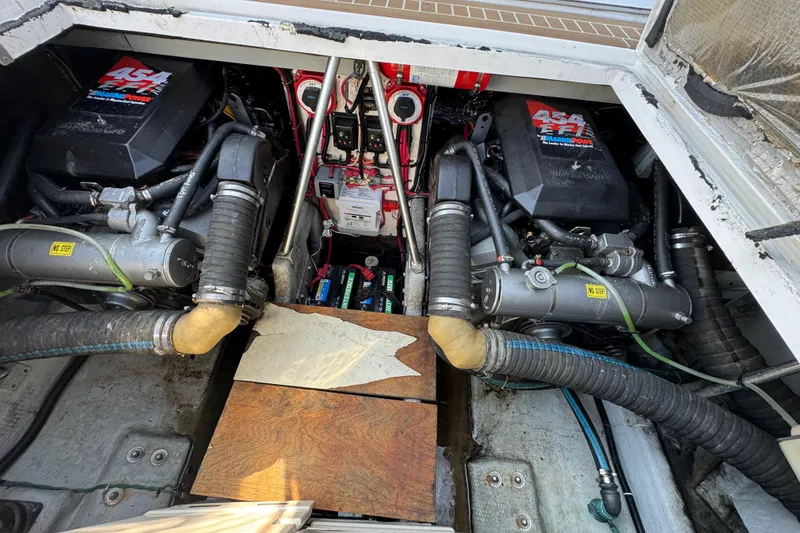 Slide: The Image of Engine compartment of a 1997 Mainship 40 Sedan Bridge with twin engines and visible components. - 33