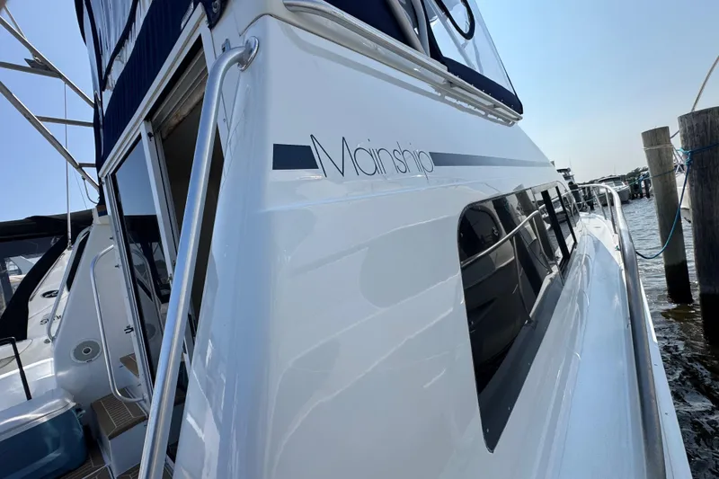 Slide: The Image of 1997 Mainship 40 Sedan Bridge yacht docked, showcasing sleek design and modern features. - 4