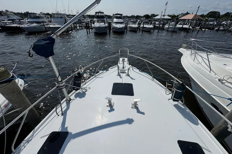 Slide: The Image of Bow view of 1997 Mainship 40 Sedan Bridge docked at marina. - 7