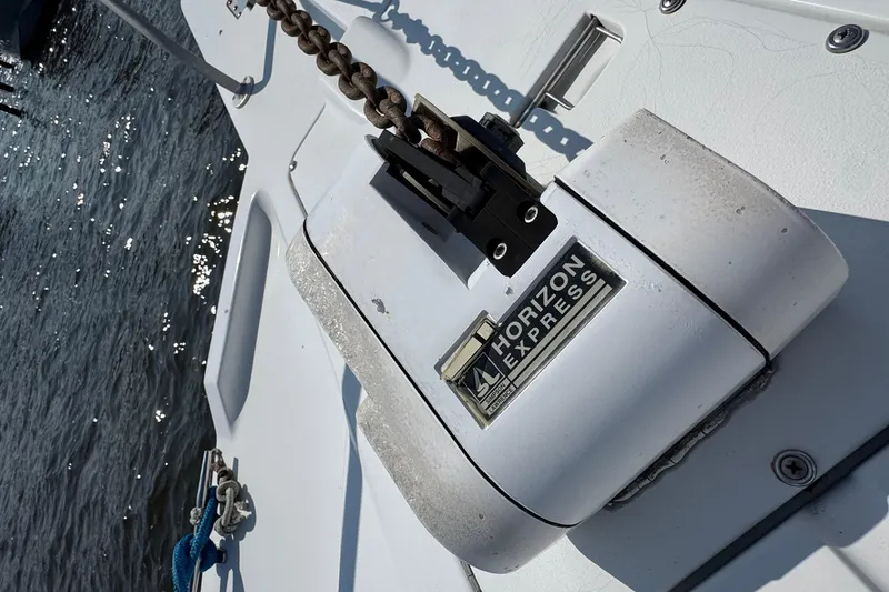 Slide: The Image of Anchor windlass on 1997 Mainship 40 Sedan Bridge, labeled "Horizon Express," near water. - 8