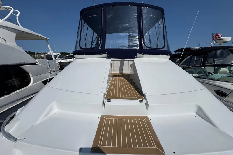 Slide: The Image of 1997 Mainship 40 Sedan Bridge yacht with sleek design and spacious deck. - 9