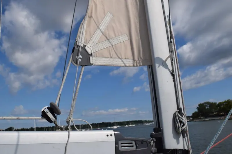 Slide: The Image of Sailboat mast and rigging on a 2001 Hunter 340 under a partly cloudy sky. - 10
