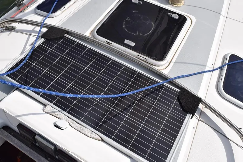 Slide: The Image of Solar panel on 2001 Hunter 340 yacht deck with blue rope and hatches. - 13