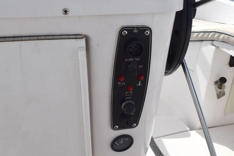 Slide: The Image of Control panel on a 2001 Hunter 340 sailboat, featuring alarm test and start buttons. - 18