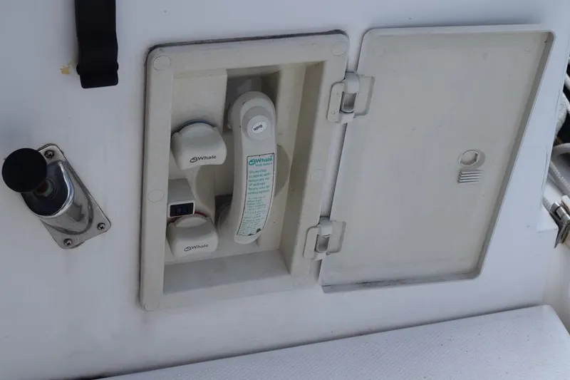 Slide: The Image of Built-in shower compartment on a 2001 Hunter 340 sailboat, featuring Whale brand components. - 19