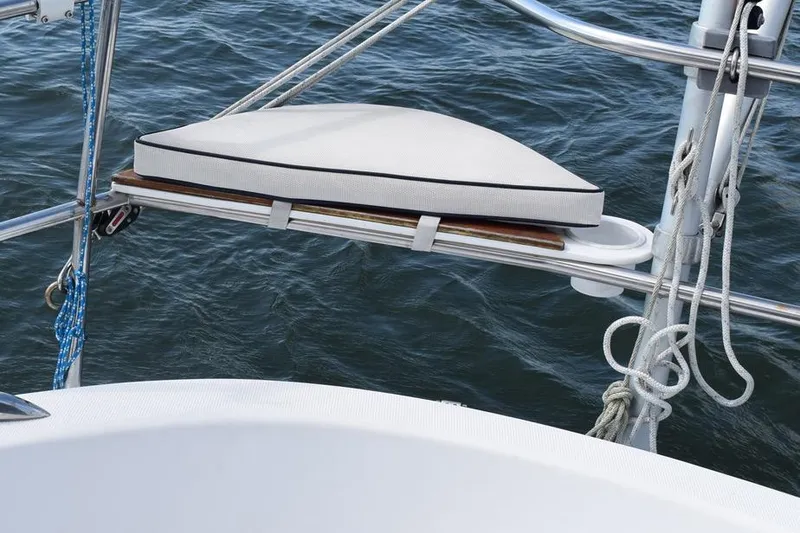 Slide: The Image of Cushioned seat on 2001 Hunter 340 sailboat, overlooking water with ropes and railing. - 20