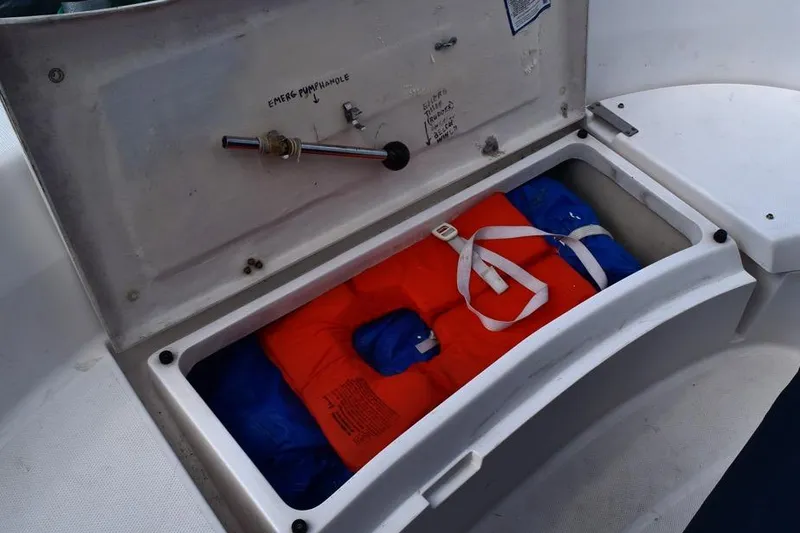 Slide: The Image of Storage compartment on a 2001 Hunter 340 sailboat with life jackets and emergency equipment. - 21