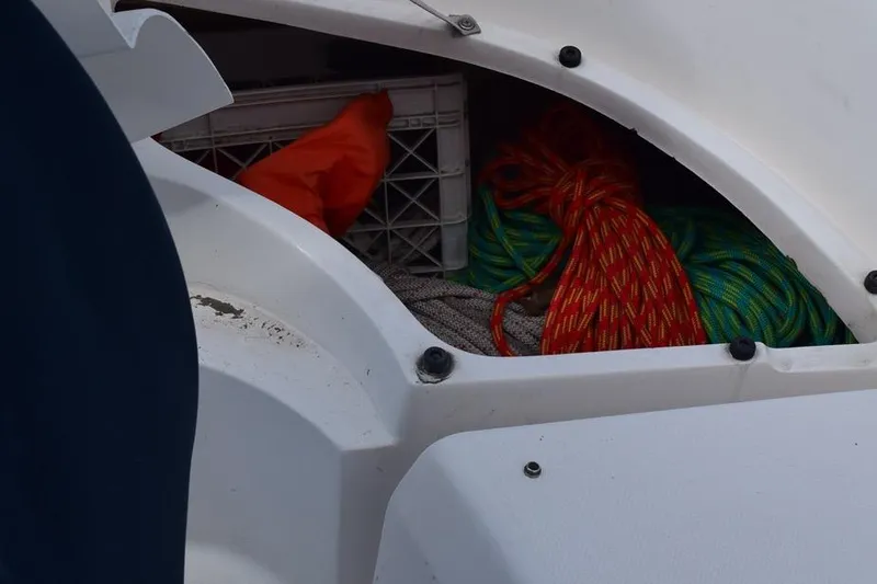 Slide: The Image of Storage compartment on a 2001 Hunter 340 sailboat with ropes and equipment. - 22