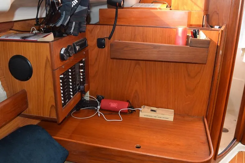 Slide: The Image of Interior of a 2001 Hunter 340 sailboat with wooden cabinetry and navigation equipment. - 34