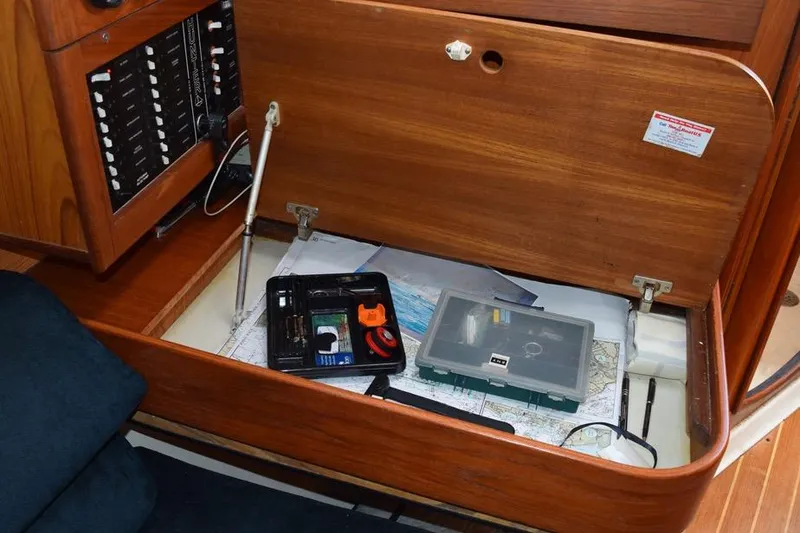 Slide: The Image of Navigation station on 2001 Hunter 340 sailboat with tools and charts. - 35