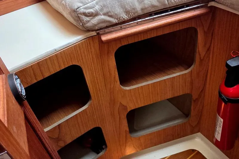 Slide: The Image of Wooden interior shelving and fire extinguisher in a 2001 Hunter 340 sailboat cabin. - 37