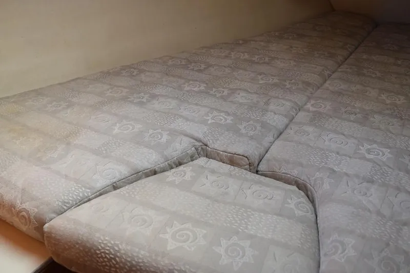 Slide: The Image of Cushioned interior of a 2001 Hunter 340 sailboat, featuring patterned upholstery. - 39