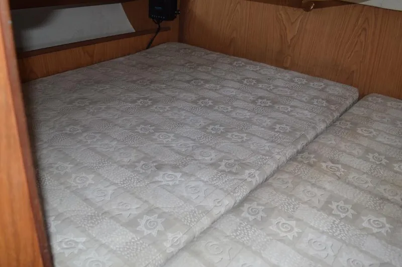 Slide: The Image of Interior cabin bed of 2001 Hunter 340 sailboat with patterned mattress. - 42