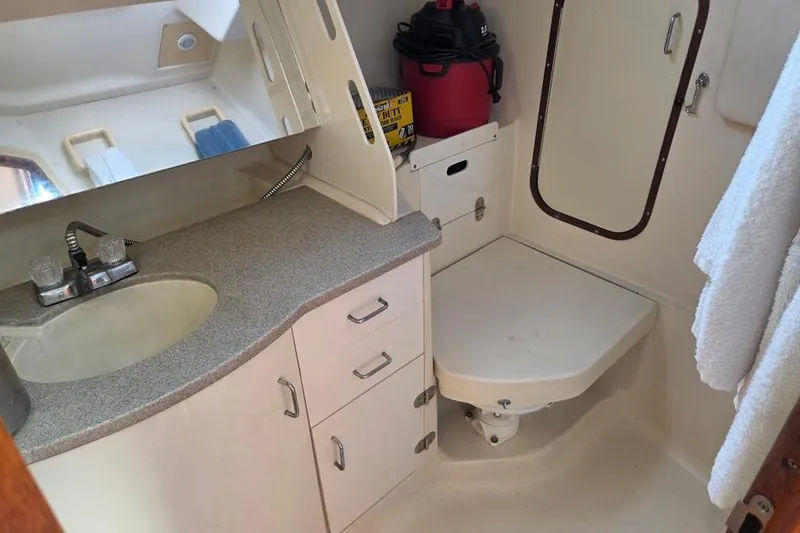Slide: The Image of Compact bathroom in a 2001 Hunter 340 sailboat with sink, storage, and toilet. - 43
