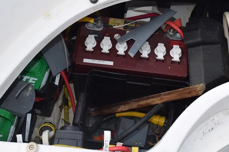 Slide: The Image of Battery compartment of a 2001 Hunter 340 sailboat with wiring and tools. - 45